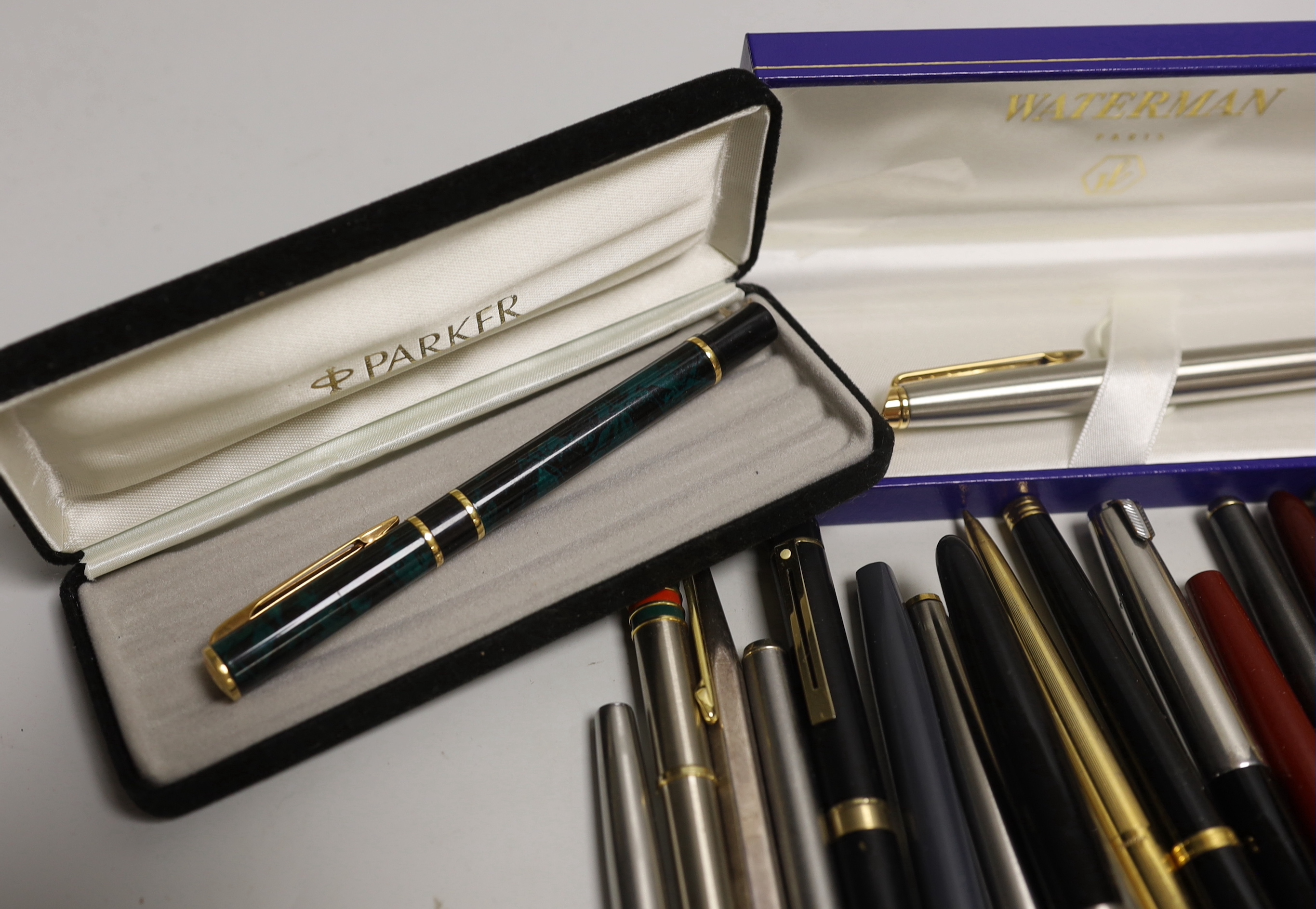 A group of fountain pens and ballpoint pens including a cased Sheaffer set